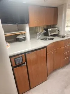 Slide: The Image of 2001 Formula 40 PC yacht kitchen with modern appliances and wooden cabinetry. - 18