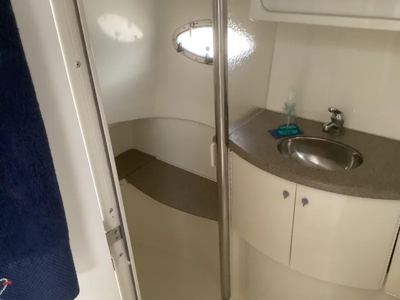 Slide: The Image of 2001 Formula 40 PC boat bathroom with sink, mirror, and porthole window. - 20