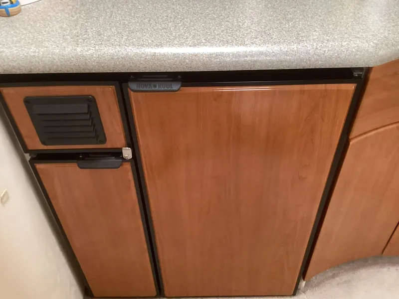 Slide: The Image of Wooden cabinetry and countertop in a 2001 Formula 40 PC boat kitchen. - 21