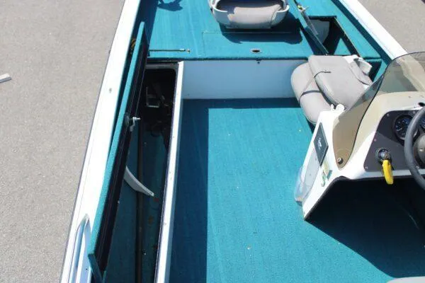 Slide: The Image of 1994 Ranger Cherokee boat interior with blue carpet and seating. - 10