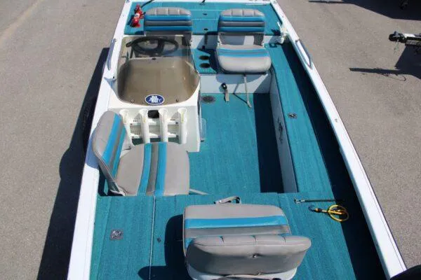Slide: The Image of 1994 Ranger Cherokee boat interior with blue and gray seating and steering console. - 11