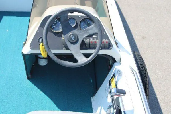 Slide: The Image of 1994 Ranger Cherokee boat dashboard with steering wheel and instrument panel. - 12