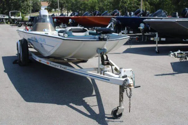 Slide: The Image of 1994 Ranger Cherokee boat on a trailer in a parking lot. - 14