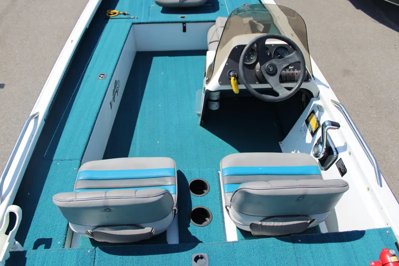 Slide: The Image of 1994 Ranger Cherokee boat interior with blue carpet and dual seats. - 6
