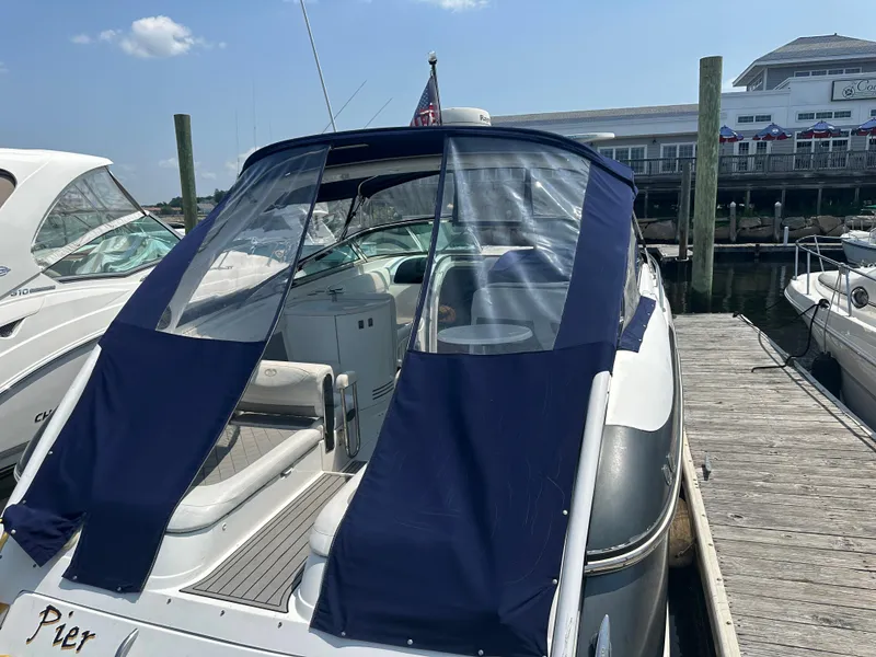 Slide: The Image of 2005 Cobalt 360 Cruiser docked with blue canvas cover. - 3