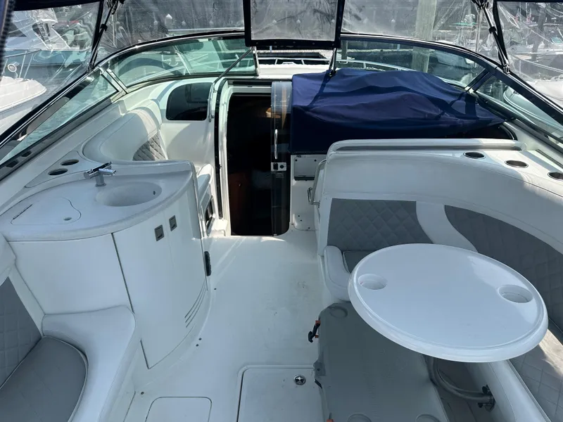 Slide: The Image of 2005 Cobalt 360 Cruiser interior with seating, table, and sink. - 6