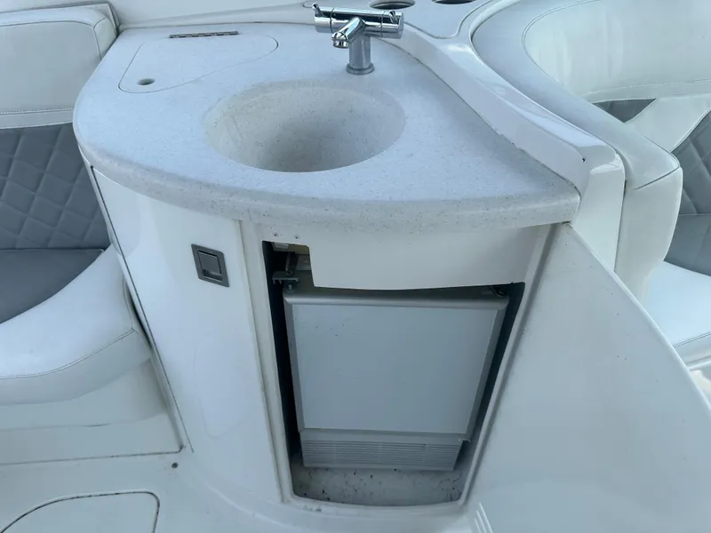 Slide: The Image of 2005 Cobalt 360 Cruiser boat sink and mini fridge in white interior. - 7