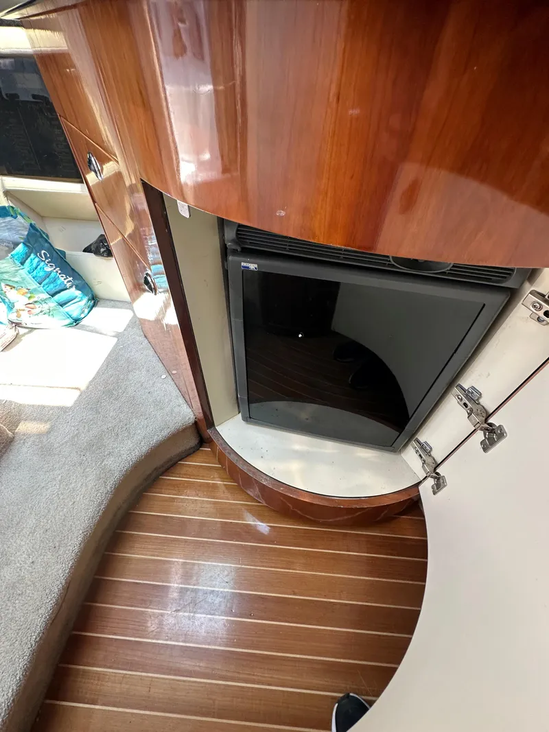 Slide: The Image of Interior of a 2005 Cobalt 360 Cruiser with wooden flooring and cabinetry. - 9