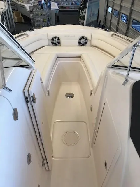 Slide: The Image of 2024 Grady-White Freedom 235 boat interior with cushioned seating and speakers. - 9