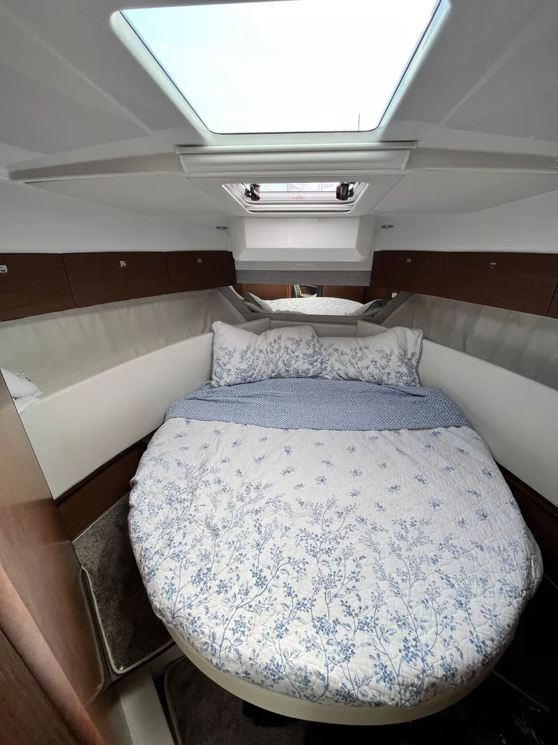 Slide: The Image of Cozy cabin interior of 2022 Jeanneau NC 1095 with skylight and floral bedding. - 19