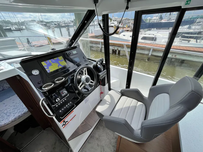 Slide: The Image of 2022 Jeanneau NC 1095 helm with navigation system, docked at marina. - 5