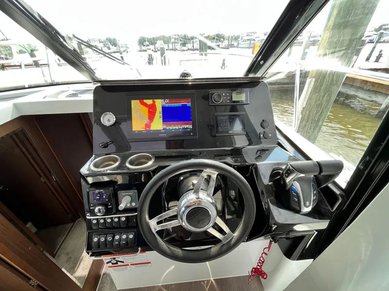 Slide: The Image of 2022 Jeanneau NC 1095 helm with navigation display and controls. - 6