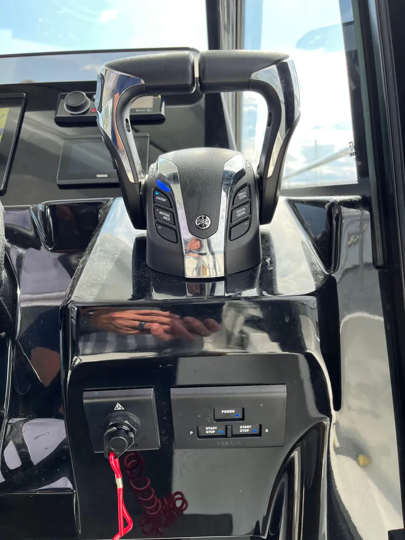 Slide: The Image of Control panel of 2022 Jeanneau NC 1095 boat with throttle and switches. - 7