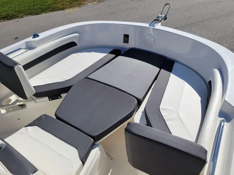 Slide: The Image of 2024 Bayliner Trophy 20 boat interior with cushioned seating and storage. - 12