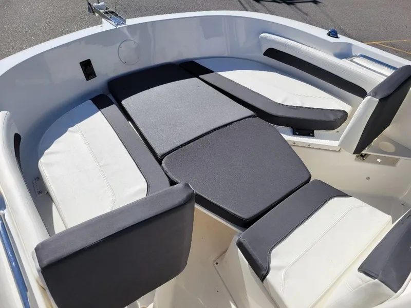 Slide: The Image of 2024 Bayliner Trophy 20 boat interior seating area with cushioned seats. - 13