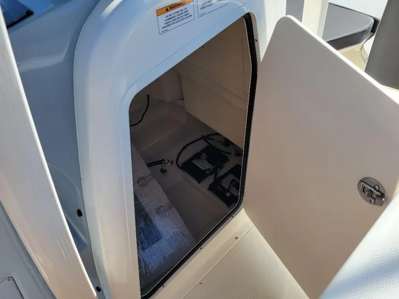Slide: The Image of 2024 Bayliner Trophy 20 storage compartment with open door. - 14