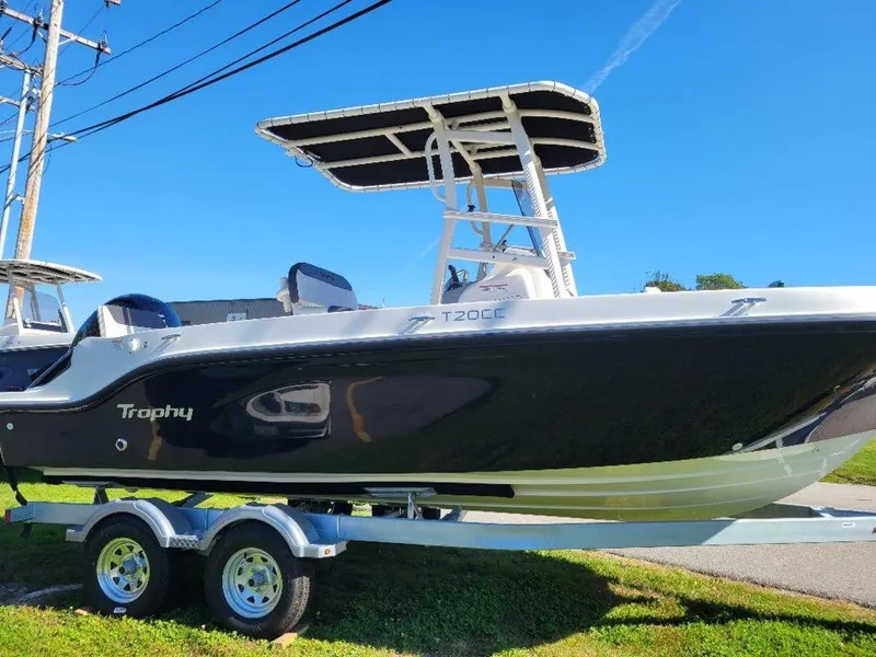 Slide: The Image of 2024 Bayliner Trophy 20 boat on a trailer under a clear blue sky. - 4