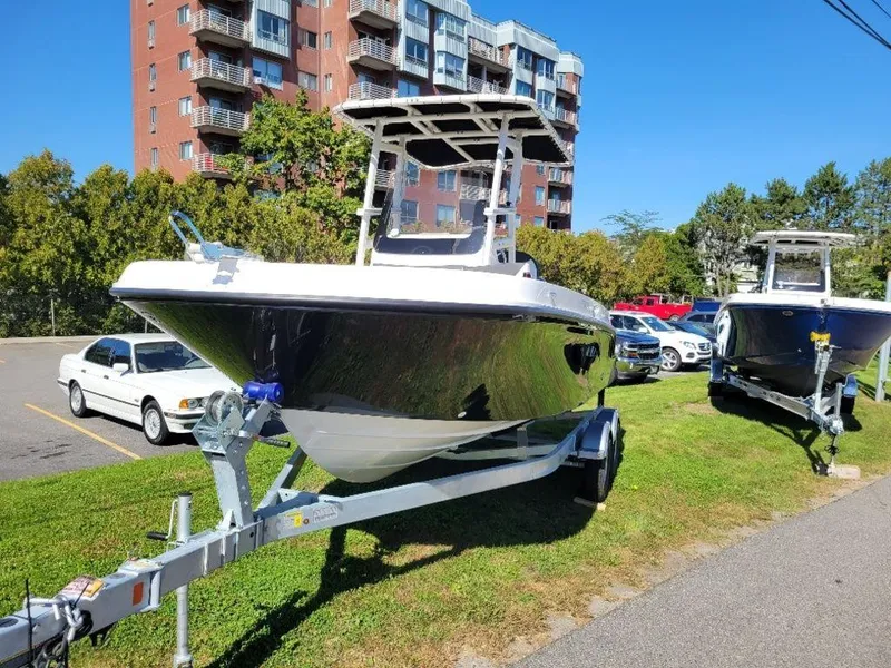 Slide: The Image of 2024 Bayliner Trophy 20 boat on a trailer in a parking lot. - 5