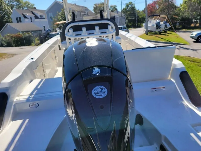Slide: The Image of 2024 Bayliner Trophy 20 boat with powerful outboard motor in a residential area. - 9