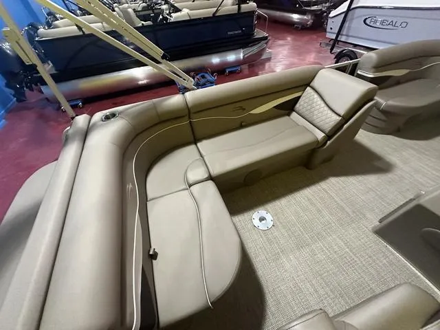 Slide: The Image of 2024 Bennington 198 SLJ boat interior with beige seating and carpeted floor. - 13