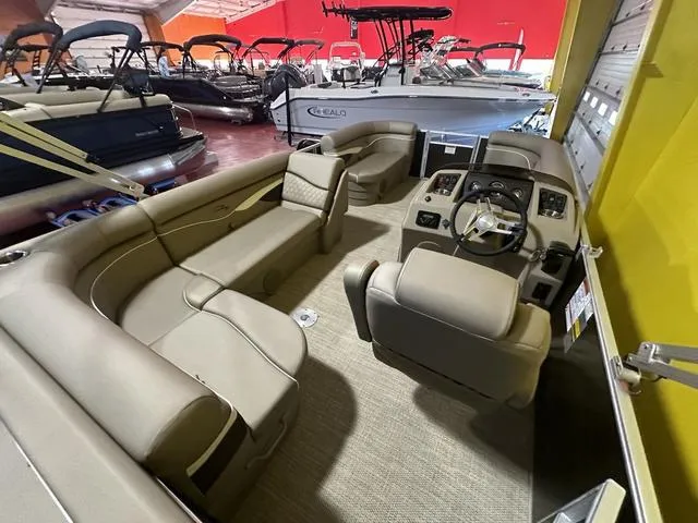 Slide: The Image of 2024 Bennington 198 SLJ pontoon boat interior with beige seating and helm. - 15