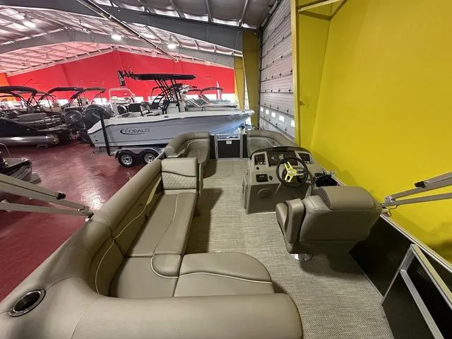 Slide: The Image of 2024 Bennington 198 SLJ pontoon boat interior in showroom with other boats. - 16