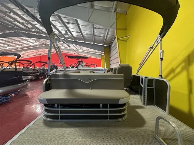 Slide: The Image of 2024 Bennington 198 SLJ pontoon boat in showroom with yellow wall background. - 17