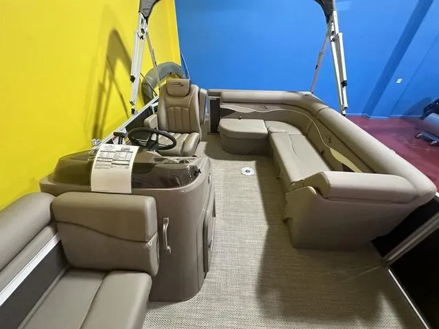 Slide: The Image of 2024 Bennington 198 SLJ pontoon boat interior with beige seating and steering console. - 9
