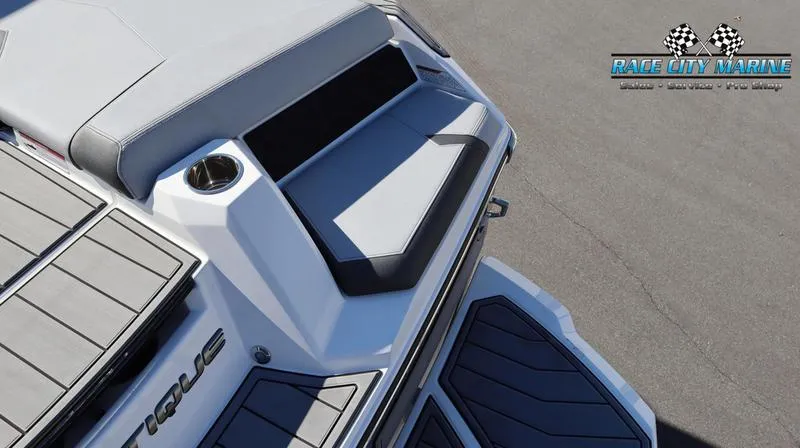 Slide: The Image of 2024 Nautique GS24 boat rear seating and deck area, Race City Marine logo. - 10