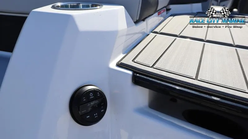 Slide: The Image of 2024 Nautique GS24 boat deck with audio controls and cup holder. - 14