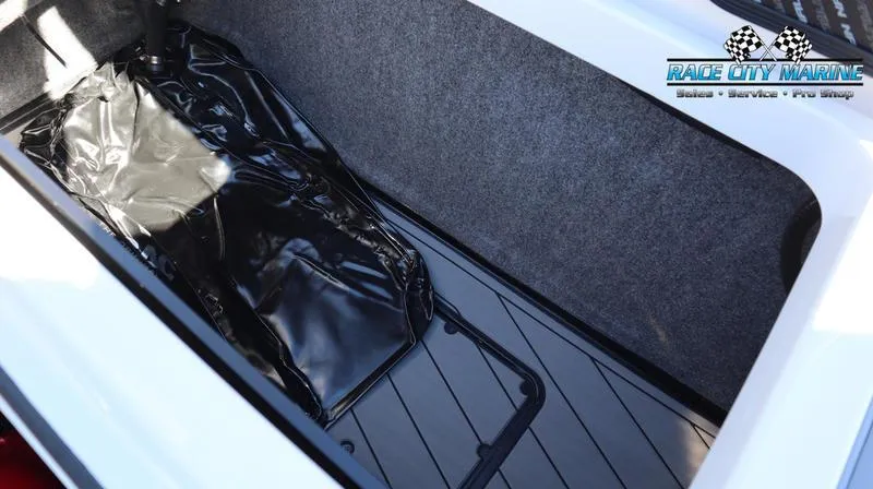 Slide: The Image of 2024 Nautique GS24 storage compartment with Race City Marine logo. - 15