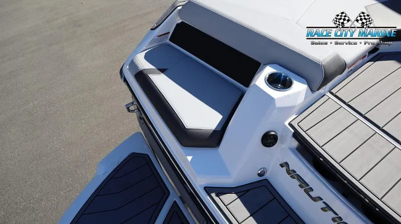 Slide: The Image of 2024 Nautique GS24 boat rear seating and deck area. - 16
