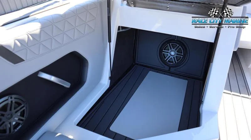 Slide: The Image of 2024 Nautique GS24 boat interior with premium speakers and seating. - 19