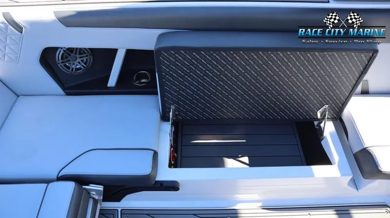 Slide: The Image of 2024 Nautique GS24 boat interior storage compartment open. - 25