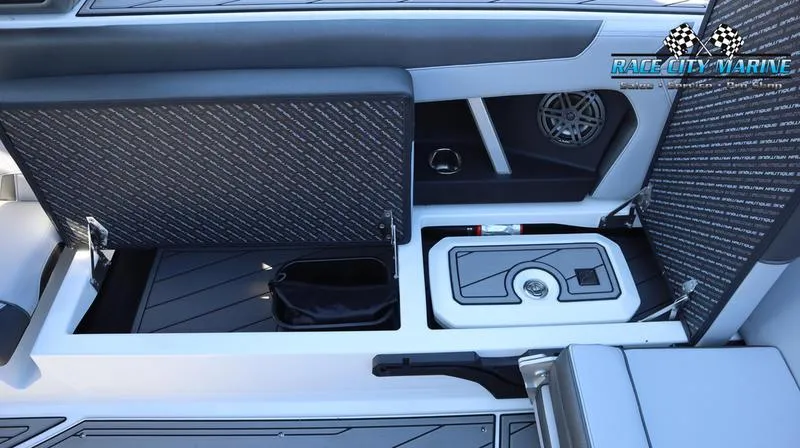Slide: The Image of 2024 Nautique GS24 boat interior storage compartments and speaker system. - 31