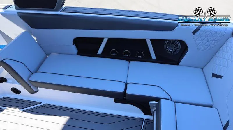 Slide: The Image of 2024 Nautique GS24 boat interior with cushioned seating and Race City Marine logo. - 36