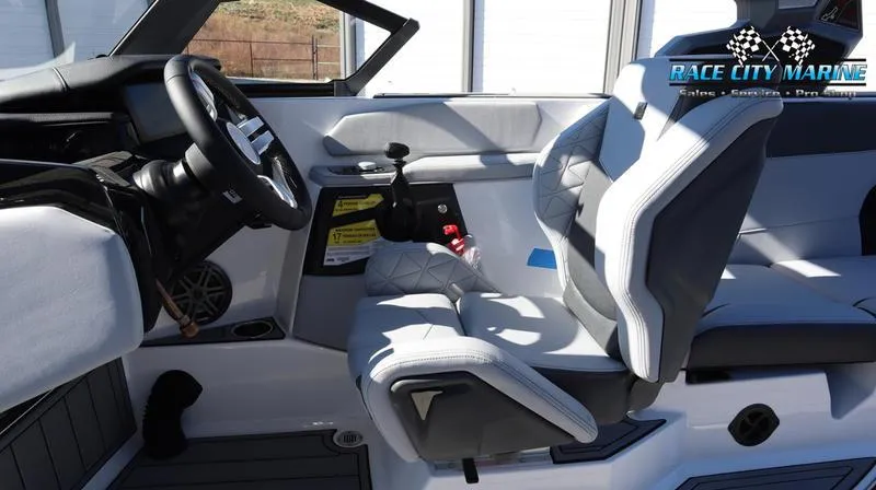 Slide: The Image of 2024 Nautique GS24 boat interior with modern steering and seating. - 39