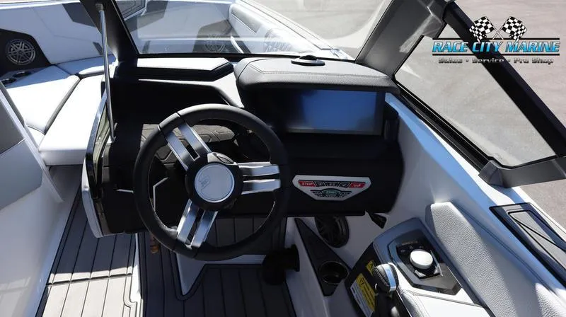 Slide: The Image of 2024 Nautique GS24 boat dashboard and steering wheel, Race City Marine logo. - 6