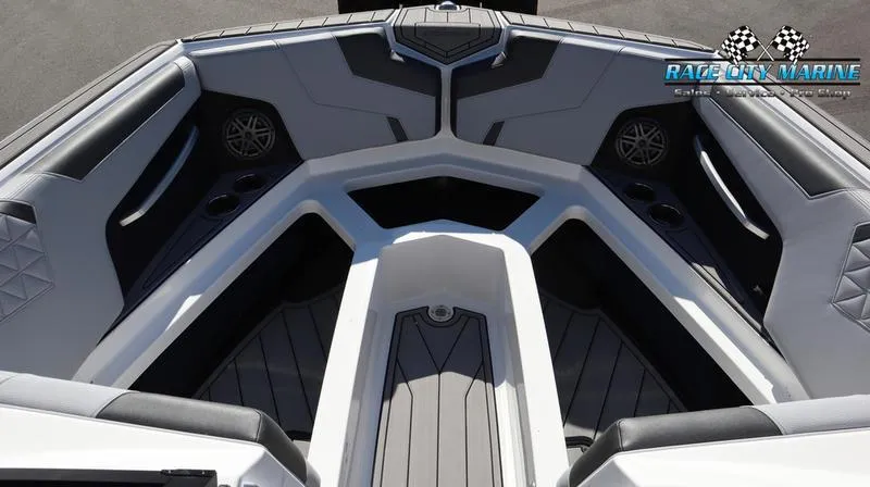 Slide: The Image of 2024 Nautique GS24 boat interior with cushioned seating and speakers. - 7