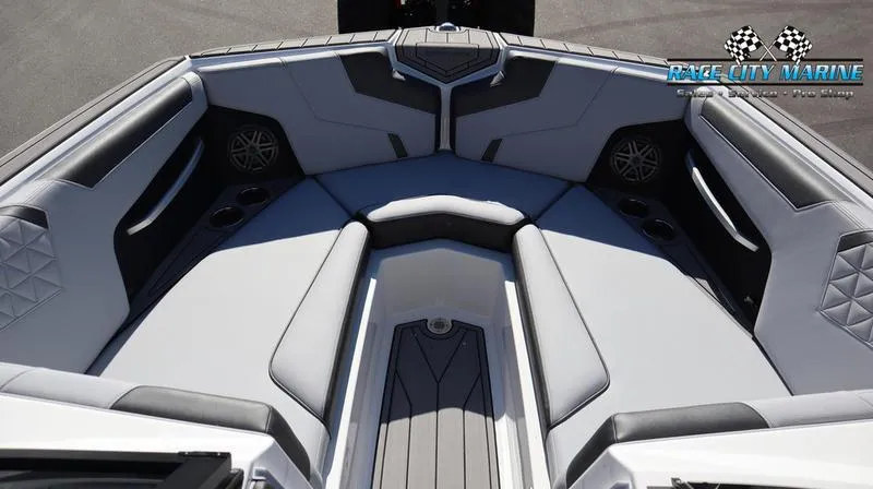 Slide: The Image of 2024 Nautique GS24 boat interior with luxurious seating and Race City Marine logo. - 8