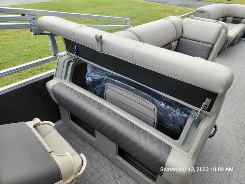 Slide: The Image of 2024 Sun Tracker SportFish 22 DLX pontoon boat interior with storage compartments. - 16