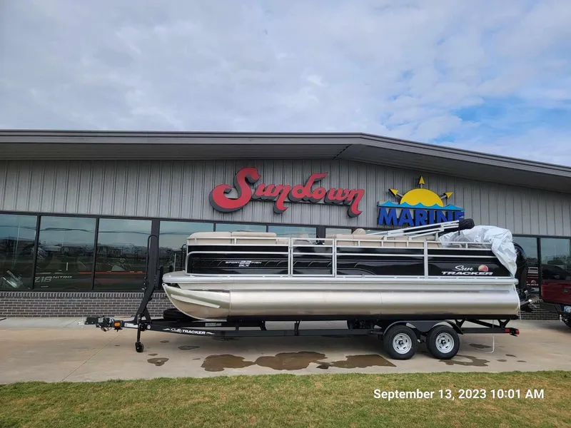 Slide: The Image of 2024 Sun Tracker SportFish 22 DLX pontoon boat at Sundown Marine dealership. - 2