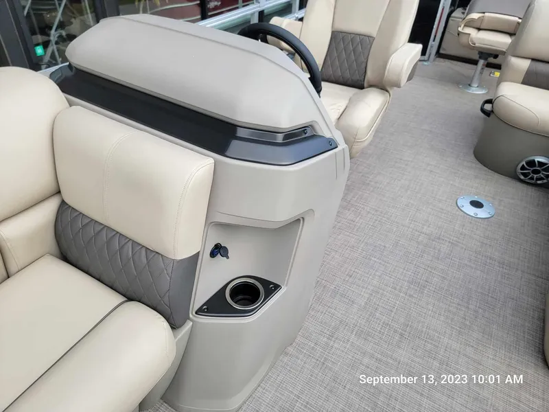 Slide: The Image of Interior of 2024 Sun Tracker SportFish 22 DLX pontoon boat with beige seating. - 26