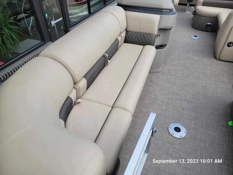 Slide: The Image of 2024 Sun Tracker SportFish 22 DLX pontoon boat interior with beige seating. - 30