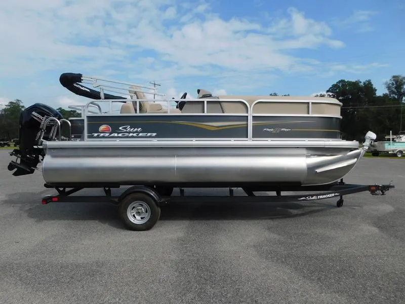 The Image of 2024 Sun Tracker Party Barge 18 DLX pontoon boat on trailer, side view. - 0