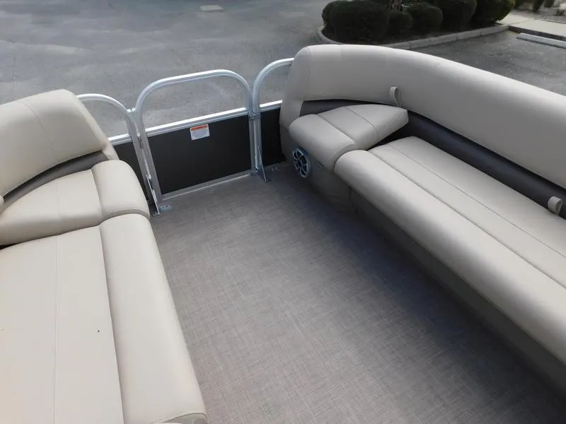 Slide: The Image of 2024 Sun Tracker Party Barge 18 DLX interior with beige seating and spacious layout. - 10