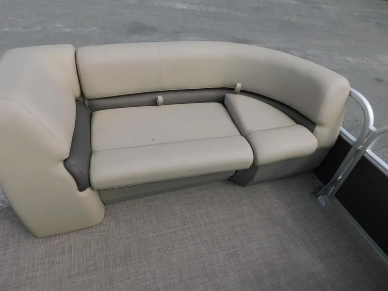 Slide: The Image of 2024 Sun Tracker Party Barge 18 DLX beige and gray seating area. - 12
