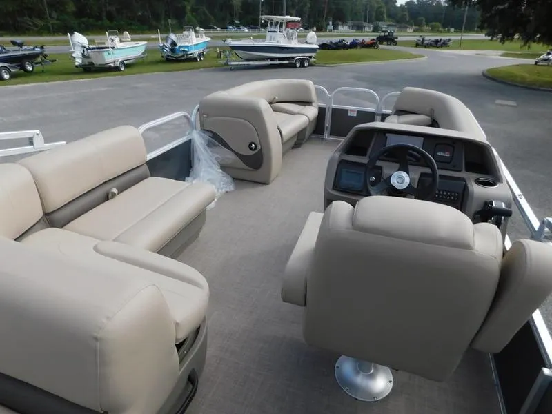 Slide: The Image of 2024 Sun Tracker Party Barge 18 DLX pontoon boat with beige seating and modern helm. - 8
