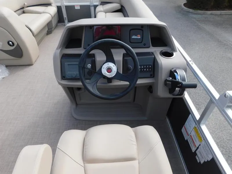 Slide: The Image of 2024 Sun Tracker Party Barge 18 DLX pontoon boat helm with steering wheel and controls. - 9