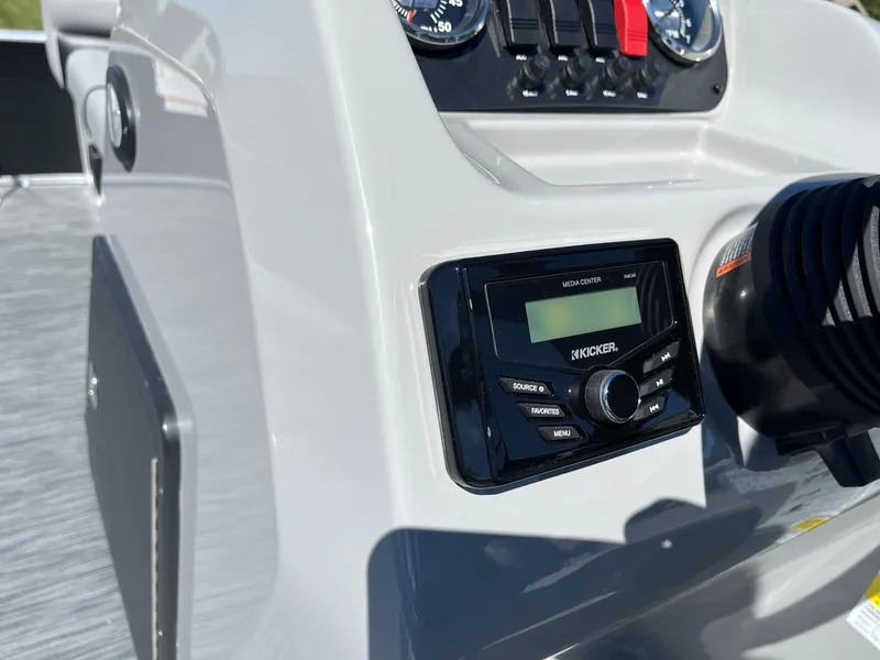 Slide: The Image of 2024 Lowe Ultra 160 Cruise boat dashboard with Kicker audio system. - 11